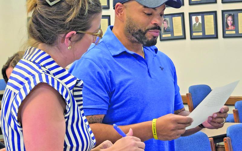 Recently appointed Bay City ISD trustee Justin Matthews, right, was officially installed to the school board Position 4 vacancy on Aug. 12. Position 4 was previously held by the late Priscilla Robinson. Sentinel Photo/ Jessica Shepard