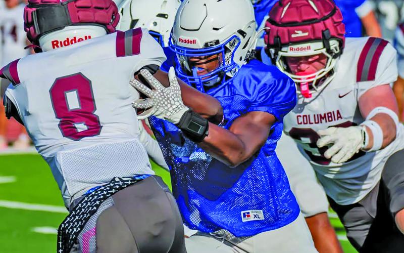 Migasproductions Tidehaven’s defense pressures a Columbus running back in the Tigers scrimmage with Columbia last week.