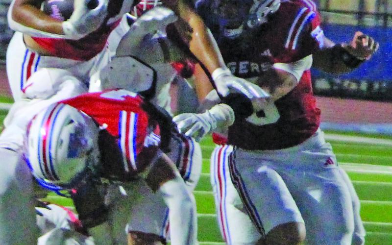 Sentinel Photo/Jessica Shepard Tidehaven’s Julius Garcia (11) battles his way for rushing yards.