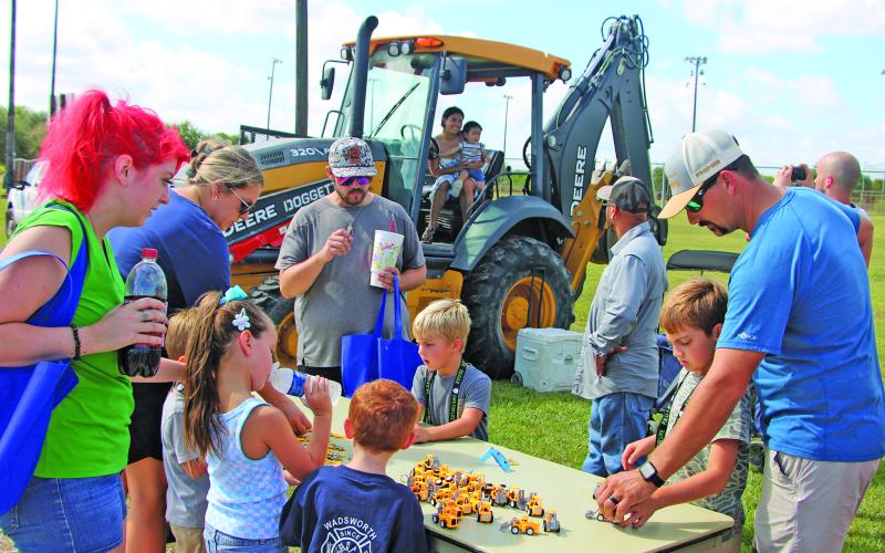 Sentinel Photo/Mike Reddell Parents and kids alike were drawn to the collection of tiny machines with a real backhoe loader as a background at the 7th Annual Touch-A-Truck Extravaganza Saturday, Sept. 12, at the Sports Complex. The event allowed kids to climb aboard giant trucks, explore heavy equipment, meet hometown heroes, and experience the thrill of sitting behind the wheel of real working vehicles - from towering CAT equipment to flashing emergency vehicles.
