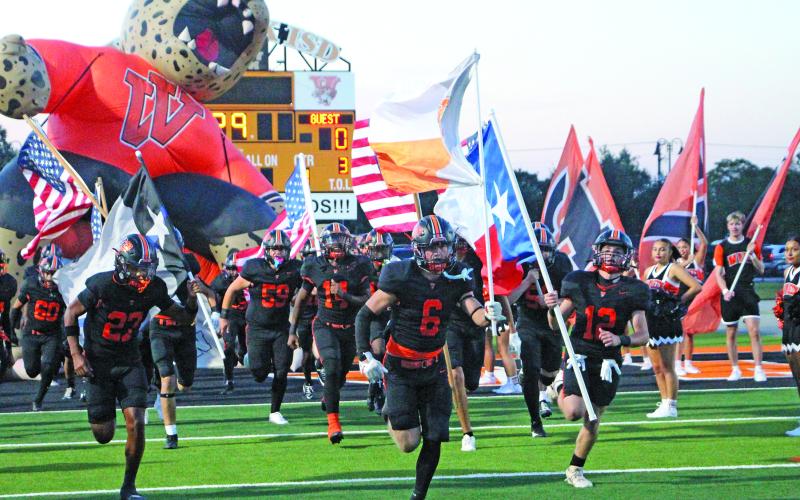 Sentinel Photo/Jessica Shepard The flag-bearing Van Vleck Leopards make their entrance to Burl McKinney Stadium last Friday for their game against Wharton. Van Vleck won 28-14. See Page 7 for more photos of the game.