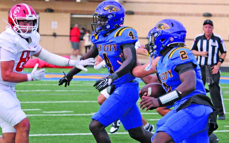 Sentinel Photo/Mike Reddell Blackcat running back Aiden Williams (4) leads the way for quarterback Keimarion Wiggins (2) to gain yardage agaist Columbus.