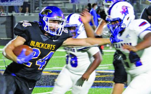 Sentinel photo/Mike Reddell Bay City junior running back Ayden Smith (24) stiff arms a Wharton defender en route to a third-quarter 22-yard touchdown run in a 21-9 win over Wharton at Memorial Stadium Friday, Sept. 10. Smith had a game-high 132 yards.
