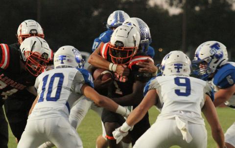 Photo/Anna Hernandez Van Vleck running back Alfredo Vazquez (1) runs the ball up the middle of St. Joseph defenders and runs into trouble. 