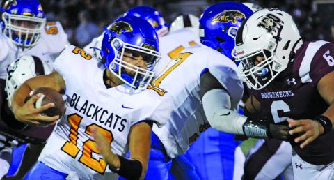 Sentinel photo/Mike Reddell Blackcat quarterback Joel Davalos (12) battles for yardage against Columbia defenders.