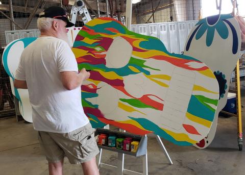 Sentinel photo/Jessica Shepard Local artist Rayleigh Conklin works on finishing up a groovy paint job on one of several large sugar skull displays for the "Day of the Dead" festival, Oct. 22. The festival is slated for noon to 10 p.m. Saturday, Nov. 6, at Le Tulle Park.