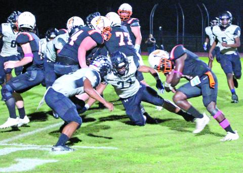 Sentinel photo/Jessica Shepard Van Vleck running back (1) puts his head down as he preparares to get past Rice defenders on the goal line.