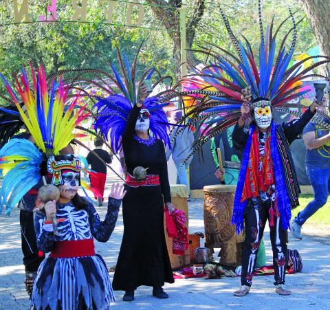 Sentinel photo/Jessica Shepard Bay City's "Day of the Dead" festival featured two costumed dance troupes as part of the live entertainment, Saturday, Nov. 6. This year's opening ceremonies were led by Calmecac Indigenous Organization, above. The organization is family-owned and dedicated to preserving and sharing traditional Indigenous Mexica philosophy, history, customs, culture, and arts to communities around Houston.