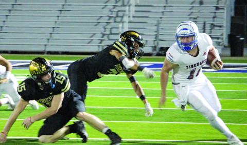 Sentinel photo/Jessica Shepard Tidehaven quarterback Logan Crow (11) looks upfield on a run against Rogers in the bi-district championship game Nov. 12. Crow was the game’s leading rusher with 304 yards and two touchdowns.