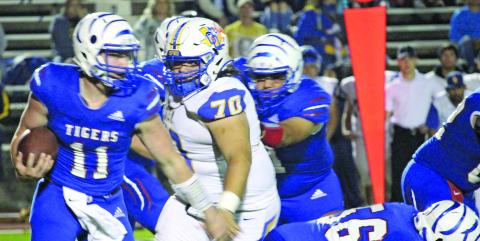 Sentinel photo/Mike Reddell Tidehaven quarterback Logan Crow (11) ran for 281 yards and four touchdowns in Saturday’s playoff against Odem..