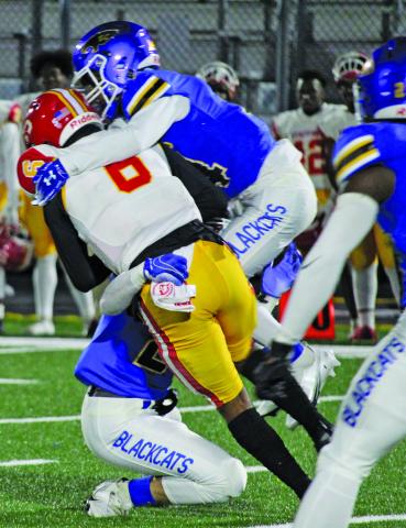 Sentinel photo/Mike Reddell Blackcats put the squeeze on a Stafford running back.