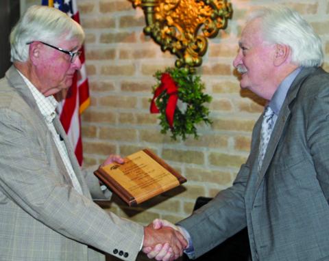 Sentinel photo/Mike Reddell  Bill Cornman, left, receives the 2021 George Holst Award from last year’s recipient, Glen Smith, at Matagorda County Economic Development Corporation’s annual banquet Dec. 8. 
