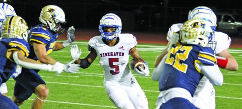 Sentinel photo/Mike Reddell Tidehaven sophomore running back Joseph Dodds (5), who had 141 all-purpose yards against Poth, looks for an opening created by his Tiger blockers.