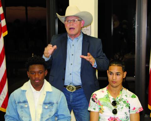 Sentinel photo/Mike Reddell Houston boxing promoter Termite Watkins (center) explains future of local boxers Kanye Gee from Bay City (left) and Tim Longoria from Palacios. The two signed professional contracts as boxers at an event Thursday, Jan. 6.