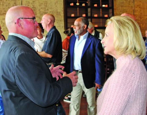 Sentinel photo/Mike Reddell John Runnels III explains a point with State Rep. Geanie Morrison at a reception for her Feb. 15.