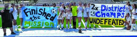 Courtesy photo The BCHS Ladycat Soccer team displays its banner proclaiming the girls undefeated district season following their 7-0 shutout of Needville Saturday, March 13, at Memorial Stadium. The girls were 14-0 in district and have compiled an overall season record of 23-1-1 and they’ll enter bi-district competition later this week.