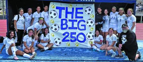 Contributed photo Ladycat Soccer members and Head Coach Darin Dobelgott show off banner proclaiming soccer program’s 250 win - since the girls started playing soccer - after defeating Sweeny there 4-0 Saturday, March 5, at Sweeny.