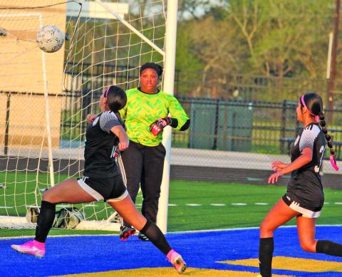 Sentinel photos/Mike Reddell Ladycats converge at goal net against Houston North Shore in a bi-district championship game that Bay City won 16-0 Saturday, March 26. 