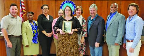 Sentinel photo/Jessica Shepard City Council joins Bay City Public Library Director Samantha Denbow, center, in celebrating the library's Texas Municipal Library Directors Association 2021 