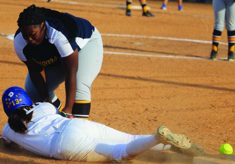 Sentinel photos /Mike Reddell  Bay City dispatched La Marque 16-0 in two innings Friday, April 1. A La Marque third baseman attempts to put out a Ladycat base runner without the ball. 