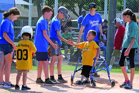 Sentinel photo/Jessica Shepard Dakota coming across home to get high 5’s from buddies.