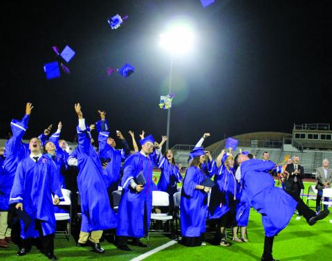 Sentinel photo/Jessica Shepard Tidehaven High School seniors launch their caps at the conclusion of commencement ceremonies at Delvin Taska Stadium, Friday, May 20.