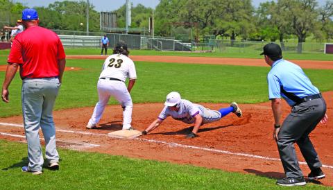 Photo by Ryan West Tidehaven runner beats the throw for a safe retirm at first