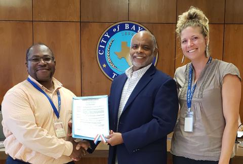 Sentinel photo/Jessica Shepard Bay City Mayor Robert Nelson, center, proclaimed May 15-21 as "National Public Works" week Tuesday, May 24. Nelson is flanked by Bay City Public Works Director Barry Calhoun and Engineering Tech Alyssa Dibbern. The proclamation states that the "city is safer, and individuals and families can enjoy the quality of life that makes Bay City special because of the dedication of public works professionals."