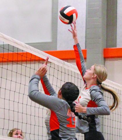 Van Vleck’s Ashlynn Winzenried (5) and Olivia Brittion (11) get the teamwork done during last week’s volleyball game against Bloomington.   Photo by  Anna Hernandez