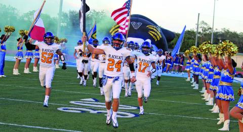 Sentinel Photo/Mike Reddell The Blackcats traditional entrance to the field marked a new season for Bay City, along with the Aristocats and Cheerleaders.