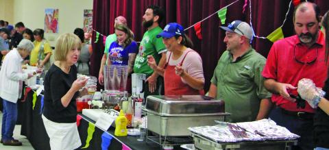 Retired Bay City teacher Connie Corman engages cooking teams at the Gourmet Guys at the Bay City Civic Center Saturday night, Sept. 24. The annual event is the only fundraiser for the Matagorda County Museum. This year’s event drew about 175 people. Sentinel Photo/Mike Reddell