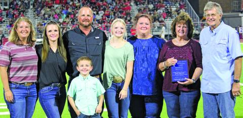 Sentinel Photo/Jessica Shepard Tidehaven Athletic Booster Club inducted Diana Fisher into the Hall of Fame during halftime Friday, Sept. 9. Family members were on hand to receive the plaque in Fisher's stead. Fisher's sporting accomplishments included volleyball, basketball, and track and field. Fisher was also the first female athlete from Tidehaven to qualify at the state track meet throughout her high school career. She also achieved All District in basketball in her sophomore, junior, and senior years.