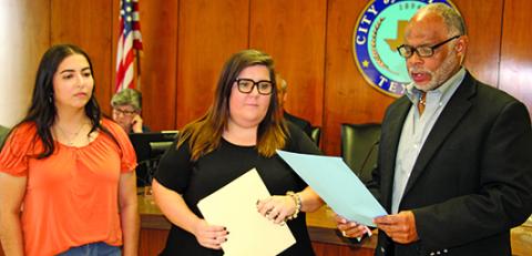 Sentinel Photo/Mike Reddell Crisis Center of Matagorda and Wharton County representives Desiree Viesca (left), Outreach Advocate, and Samanth Counts, Outreach Manager, listen as Mayor Robert Nelson reads the city’s proclamation declaring October as Domestic Violence Awareness Month.