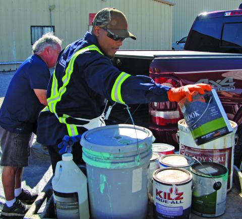 Sentinel Photo/Mike Reddell The Annual Household Hazardous Waste Collection Day was at the Matagorda County Fairgrounds Saturday, Oct. 1. This man with Clean Harbors helps remove a paint can from a pickup truck. 