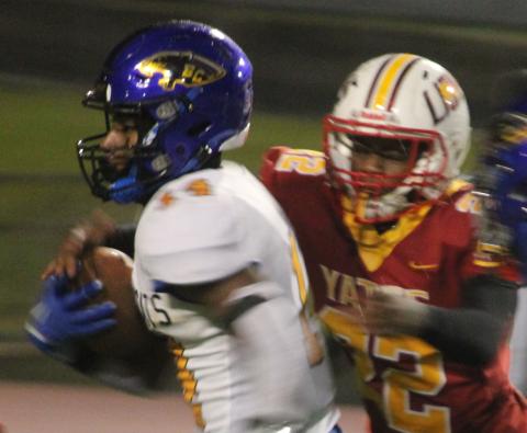 Sentinel photo/Mike Reddell Bay City running back Paris Fox (14) picks up yardage against Yates in the bi-district playoff in Houston, Friday, Nov. 11.