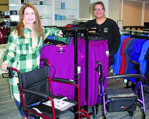 Sentinel Photo/Mike Reddell Help Inc. Business Development Manager Renee Laslie, left, and a fellow Help Inc. employee show off just some of the medical supplies available at the business during Christmas Around the Square, Nov. 17. Help Inc. also offers in-home care services and scrubs.