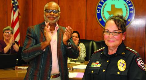 Sentinel Photo/Mike Reddell New Police Chief Christella Rodriguez stands amid loud applause led by Mayor Robert Nelson before a packed City Council Chamber after he administered her oath of office at council’s meeting Dec. 6.