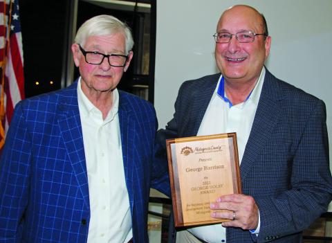 Photo by Mike Reddell Bill Cornman presents George Holst Award to George Harrison