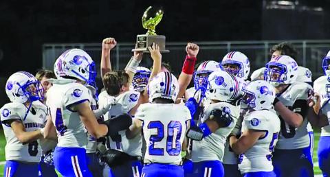 Courtesy Photo Tidehaven football team members celebrate the trophy designating them as the UIL Regional Semifinal Champions after defeating Brazos last Friday in Rosharon. The Tigers will travel to San Marcos this Friday to play Poth in the quarterfinal playoff at Texas State University.