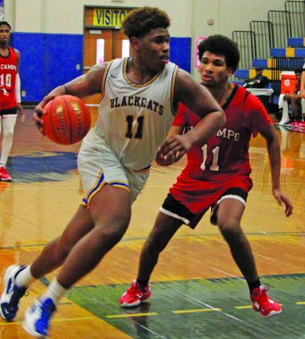 Sentinel Photo/Mike Reddell Blackcat forward Carlon Jones (11) drives against an El Campo defender at the Bay City Basketball Tournament last week.