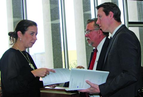 Sentinel Photo/Mike Reddell During discussions on the PCC Chemicals tax abatement request, BCCDC Executive Director Jessica Russell confers with MCEDC Executive Director Mike Ferdinand (center) and Tony Schum, Kroll director of site selection and incentives. There was a pause when County Attorney Jennifer Chau, via phone, noted the need to change a definition in the contract with PCC.