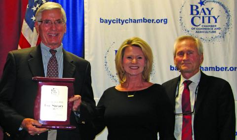 Sentinel Photo/MaLinda Reddell Loy Sneay shows off his 2022 Man of the Year award with Danyel Biggerstaff and Arthur Milberger, last year’s recipient. who introduced Sneary at the Bay City Chamber of Commerce and Agriculture banquet Thursday, Jan. 19.