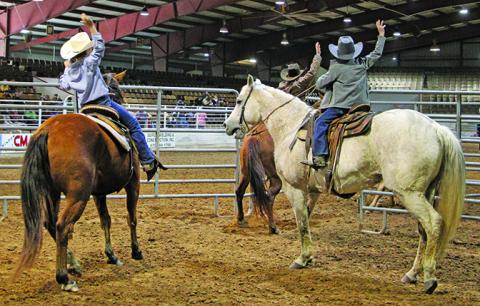 Matagorda County Fair events Saturday afternoon, Feb. 18, included youth and adult team penning. At left, a team indicates the job is done. Later that day was the Ranch Rodeo and Wild Cow Saddling. Sentinel Photo/Mike Reddell