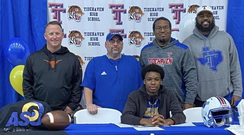Tidehaven standout receiver Ti’Shaun Davis, seated, signed a commitment to play football with Angelo State at a recent signing ceremony. Standing with Davis are, from left, Tidehaven coaches Bill Russell, David Lucio, Darren Johnson and Melvin White. Contributed photo