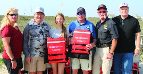 Sentinel Photo/Jessica Shepard Matagorda leaders and county officials joined Morgan Matherne (third from left) in launching her Girl Scout project to provide free life jackets to Matagorda Beach visitors Sunday, March 12. Shown, from left, are: Precinct 2 Justice of the Peace Suzanne Sullivan; Kent Pollard; Matherne; Precinct 2 Commissioner Mike Estlinbaum; Precinct 2 Constable Keith Sullivan; and County Judge Bobby Seiferman.