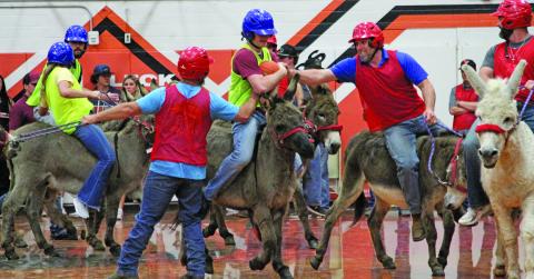 Anna Hernandez photo Van Vleck High School senior Carter McKnight tries his best to hold on to the ball when he is attacked by the Van Vleck Community Team during the recent Donkey Basketball game at VVHS.