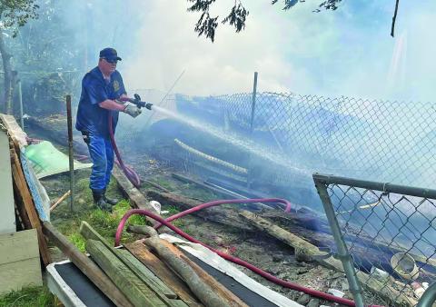 Photo by Fire Marshal Dan Shook A Bay City firefighters battles a blaze caused by an unattended barrell container.