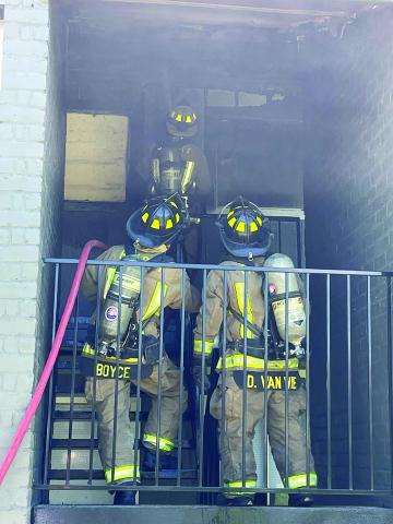 Photo by Dan Shook Bay City firefighters battle a blaze in a Hiram Brandon apartment building stairwell April 28.