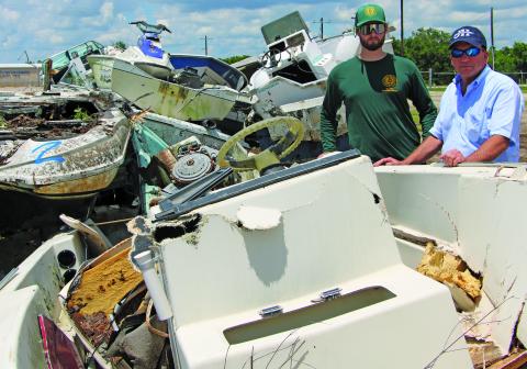 Sentinel Photo/Mike Reddell A total of 56 boats were collected in Matagorda County’s vessel return program, said Precinct 2 Commissioner Mike Estlinbaum. Estlinbaum, right, is shown with Kurt Adams, response officer with the General Land Office (GLO), with some of the early boats turned in last week. Estlinbaum thanked those who hauled the boats to the Fairgrounds for proper disposal and help rid the county of eyesore boats littering property. 
