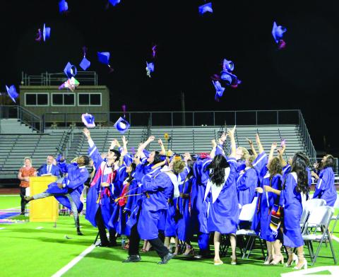 Sentinel Photo/Jessica Shepard Newly minted Tidehaven graduates throw their mortarboard caps.